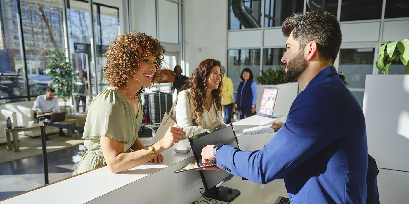 A man and woman at a check-in desk