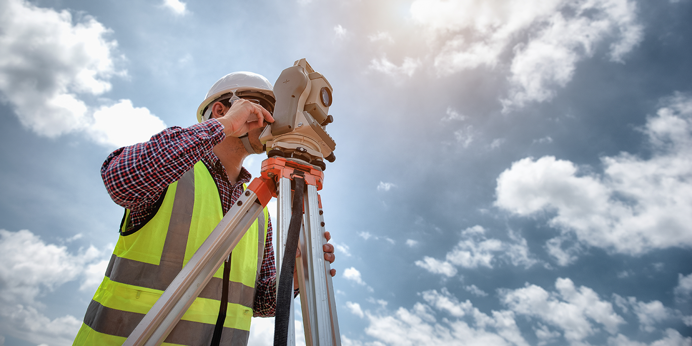 A person using surveying equipment