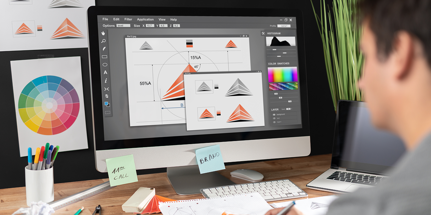 A man using graphic design software on a computer