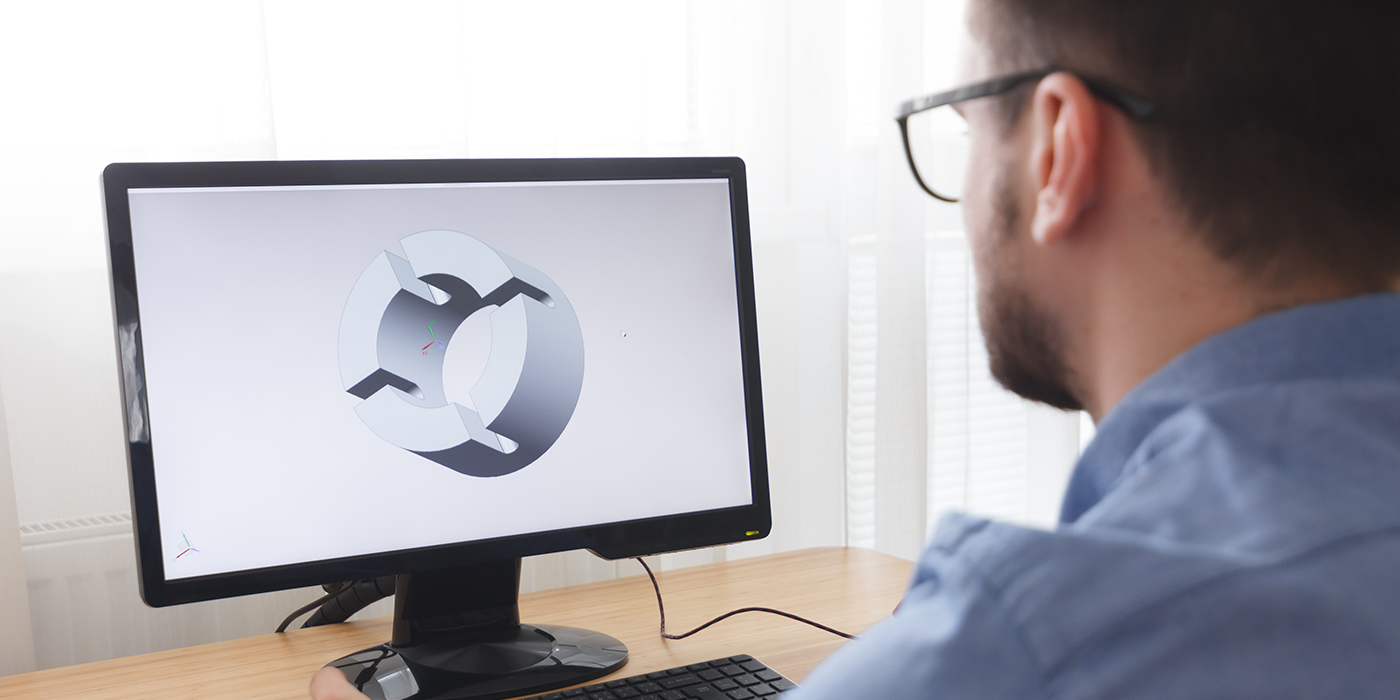 A man using 3D modeling software on a computer