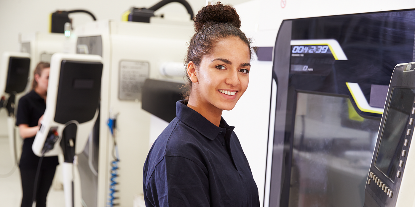 A woman using industrial machinery