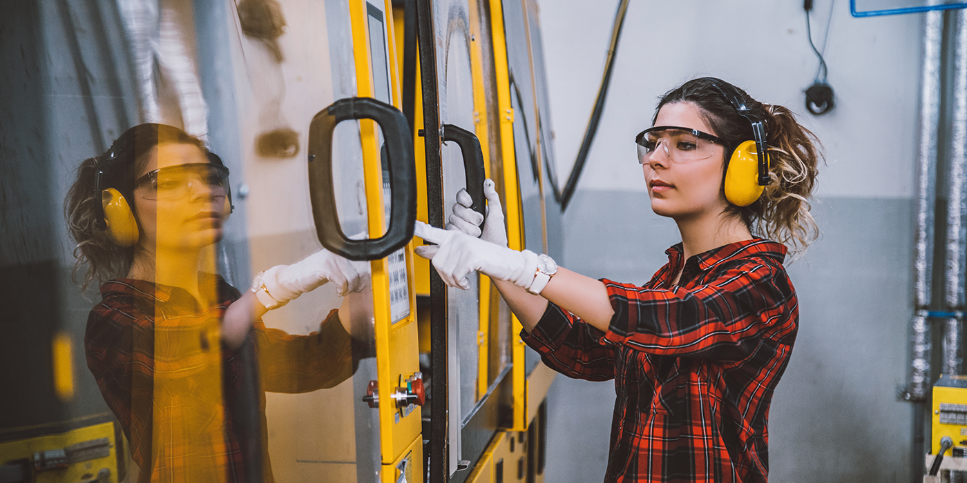 A woman using industrial machinery