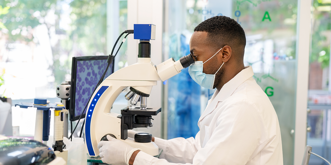 A man using a microscope